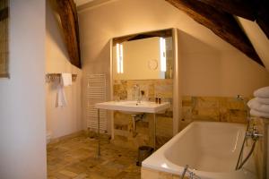 a bathroom with a sink and a bath tub at Hotel Börse in Görlitz +57 photos