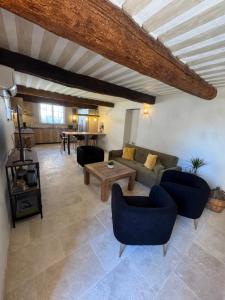 a living room with a couch and chairs and a table at O Bastidon du Ventoux in Bédoin