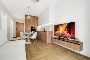 a living room with a large tv on a wall at Neon Apartments Centrum in Częstochowa