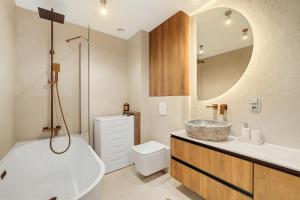 a bathroom with a sink and a toilet and a mirror at Neon Apartments Centrum in Częstochowa +18 photos