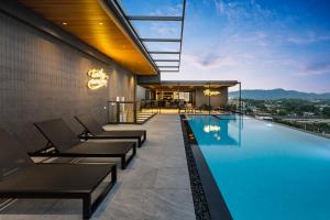 a swimming pool on the side of a building at The Turtle Hotel Bangsaen in Ban Thai Don (1)