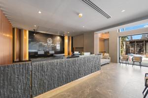 a lobby of a hotel with a reception counter at The Turtle Hotel Bangsaen in Ban Thai Don (1)