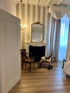 a living room with a dog on a cart in front of a fireplace at Palazzo Calderini in Castiglion Fiorentino