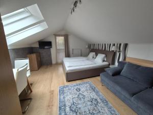 a living room with a bed and a couch at Hotel Gletschermühle in Flattach +39 photos