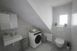 a white bathroom with a sink and a washing machine at Plitvice Harmony one - seven person in Smoljanac +25 photos