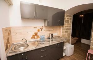 a kitchen with a sink and a counter at Green Garden Hotel in Baku +42 photos