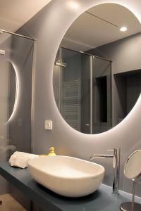 a bathroom with a white sink and a mirror at Dimora Veneziani in Bisceglie +14 photos