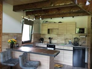 a kitchen with a large island in a room at Olchowym Domek in Gostynin