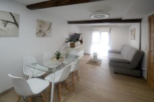 a living room with a glass table and a couch at Apartamentos California in Béjar