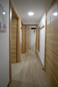 a hallway with wooden doors and wooden floors at Apartamentos California in Béjar