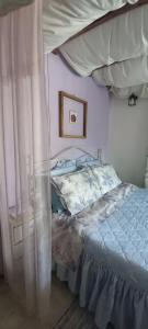 a bedroom with a bed with a canopy at Elizas house in Nea Makri