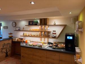 a kitchen with a counter with food on it at Europa Pension zum Grünen Baum in Rust