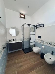 a bathroom with a shower and a toilet and a sink at Holiday Home Tarinuzza in Lipari +48 photos
