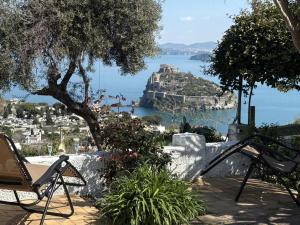 a patio with a view of the amalfi coast at Barracuda Suite Sea View & Dinner Experience in Ischia Town