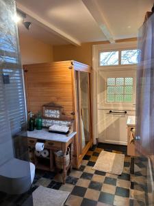 a bathroom with a shower and a table and a toilet at Studio 1772 in Kamperland