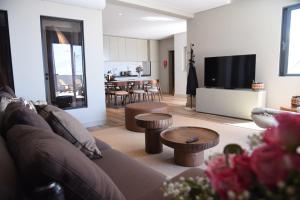 a living room with a couch and a tv in it at Villa Macedo in Ponta do Sol