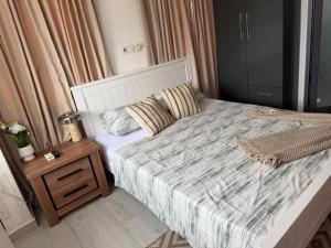a small bedroom with a bed and a night stand at 1 Pees Place in Christiansborg