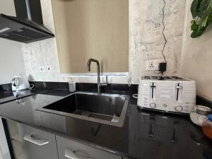 a kitchen with a sink and a stove at 1 Pees Place in Christiansborg +27 photos