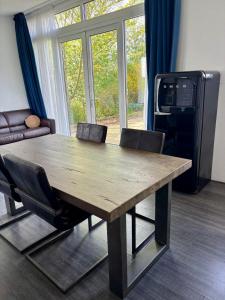 a wooden table and chairs in a living room at Waegen Uus in Wolphaartsdijk +17 photos