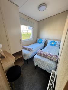 a small room with two beds and a window at Kieras View At Bideford Bay in Bideford +43 photos