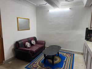 a living room with a couch and a table at Pahuna Homestay in Kathmandu