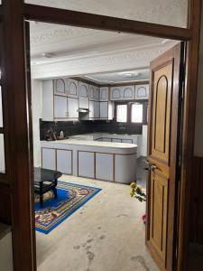 an open door to a kitchen with a table at Pahuna Homestay in Kathmandu