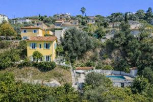 a yellow house on top of a hill at House on the Hill in Nice