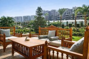 a patio with couches and a table on a balcony at Grand Tibarose Hotel in Cairo
