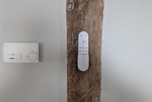 a remote control on a wall next to a switch at Elantxobe Plaza VT in Elanchove