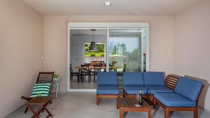 a living room with blue furniture and a dining room at Casa Tijana by Villas Guide in Krk