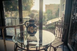 a vase sitting on a glass table on a balcony at Hotel Vila Bregu in Tirana