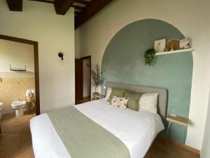 a bedroom with a large white bed and a bathroom at Agriturismo Fontelini in Cingoli +62 photos