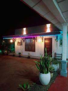 a house with purple lights on it at night at Moonlight Resort in Anuradhapura