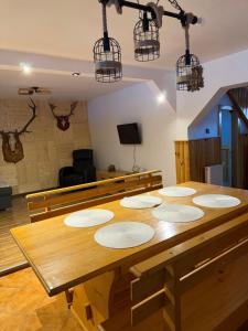 a wooden table in a room with aasteryasteryasteryasteryasteryasteryasteryastery at Cabana Trofelor in Comandău