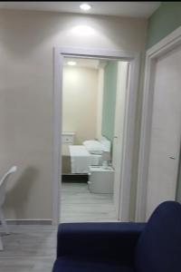 a room with a mirror and a bedroom with a bed at B&B Costa d'Amalfi Bellizzi in Bellizzi