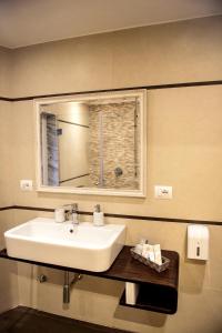 a bathroom with a sink and a mirror at Hotel Vila Bregu in Tirana +28 photos