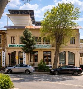 two cars parked in a parking lot in front of a building at Hotel Sofia Samarkand in Samarkand +9 photos