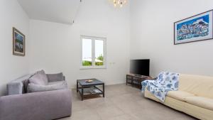 a living room with a couch and a table at Casa Tijana by Villas Guide in Krk
