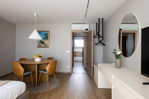 a small room with a table and a bedroom at Horizon 180 in Varna City