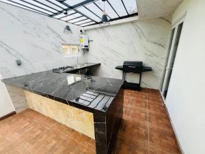 a large kitchen with a counter in a room at Yolcehuikalli - Loft Cuetzalan in Cuetzalán del Progreso