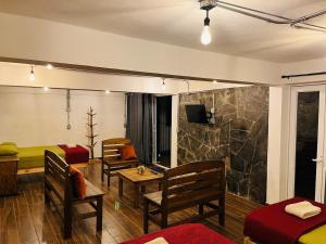 a room with two beds and a living room at Yolcehuikalli - Loft Cuetzalan in Cuetzalán del Progreso