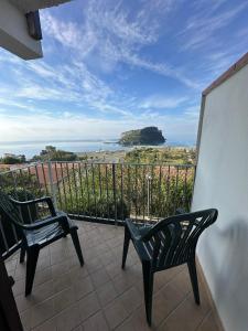a balcony with two chairs and a view of the ocean at Hotel Normanni in Praia a Mare