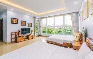 a bedroom with two beds and a large window at Villa nt 48 FLC Thanh Hoá in Sầm Sơn +24 photos
