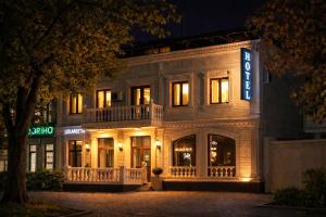 a building with a sign on the front of it at Hotel Sofia Samarkand in Samarkand