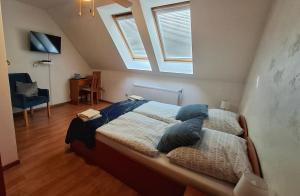 a bedroom with a large bed with a window at Penzión Villa Agnes in Smolenice
