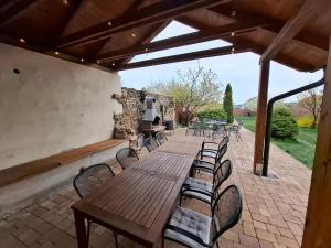 a wooden table and chairs on a patio at Penzión Villa Agnes in Smolenice