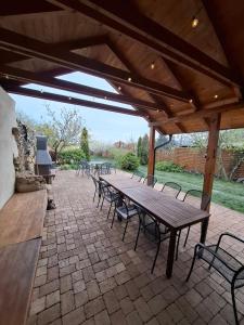 a wooden picnic table and chairs under a pavilion at Penzión Villa Agnes in Smolenice
