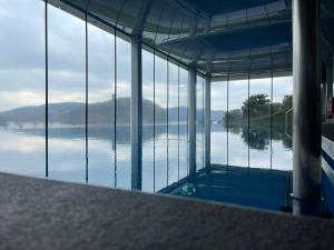 a swimming pool with a view of the water at Słoneczna DWÓJKA Resort SPA in Gródek Nad Dunajcem