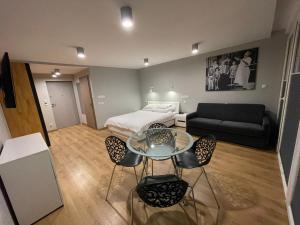 a living room with a bed and a table and chairs at Słoneczna DWÓJKA Resort SPA in Gródek Nad Dunajcem +52 photos