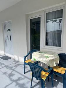 a table and chairs on a porch with a window at Apartment White Rose in Bar +41 photos